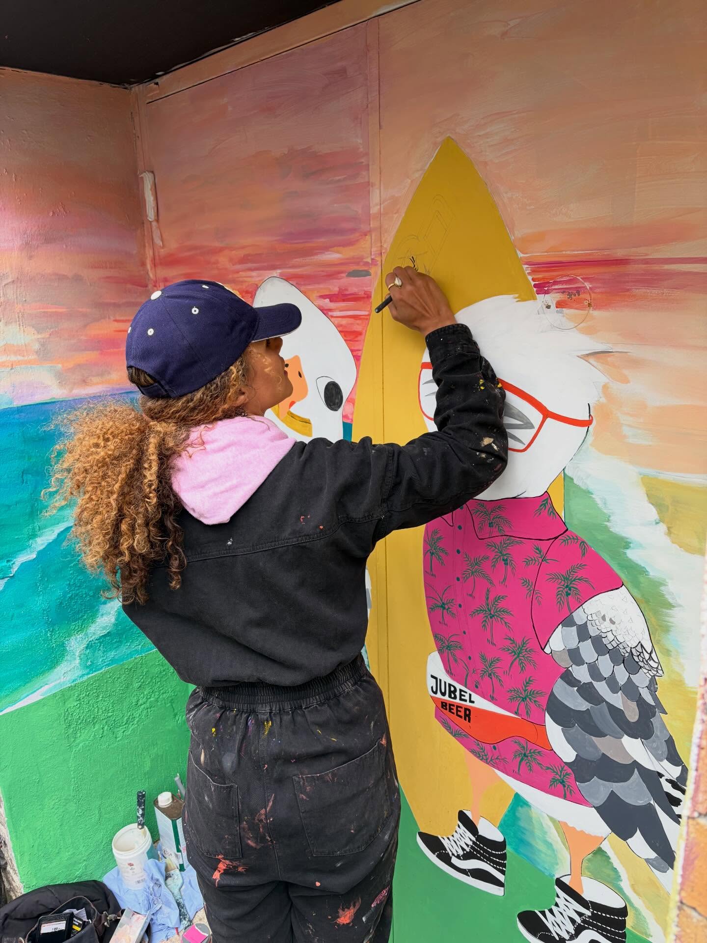 Sara painting the Seagulls in Vans mural, Newquay