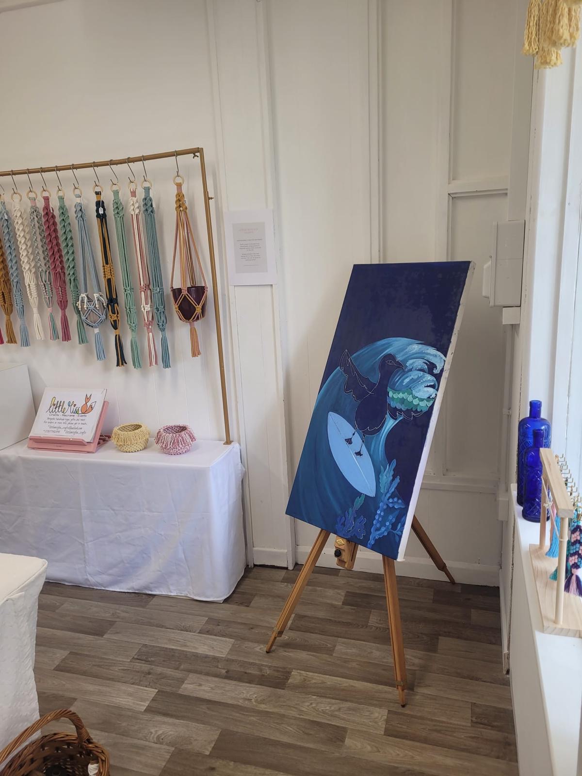Surfing seagull canvas on easel at the pop-up gallery